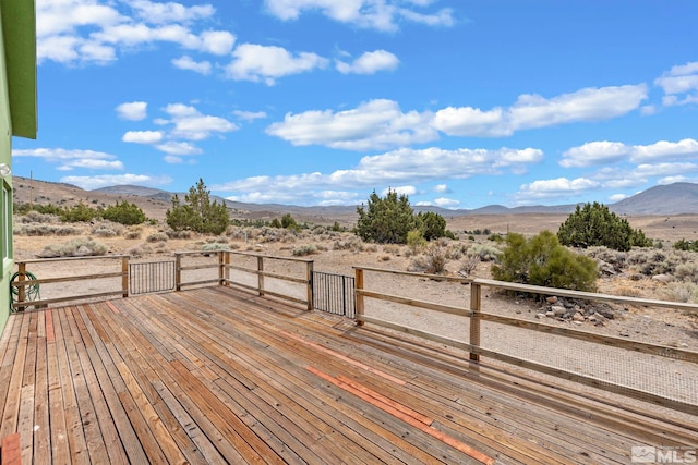 wooden terrace featuring a mountain view