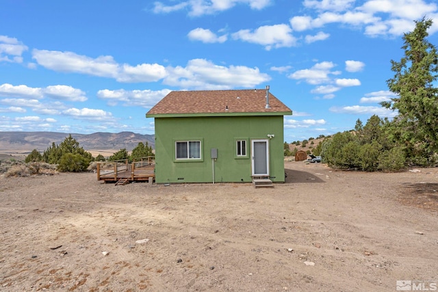 back of property featuring a mountain view