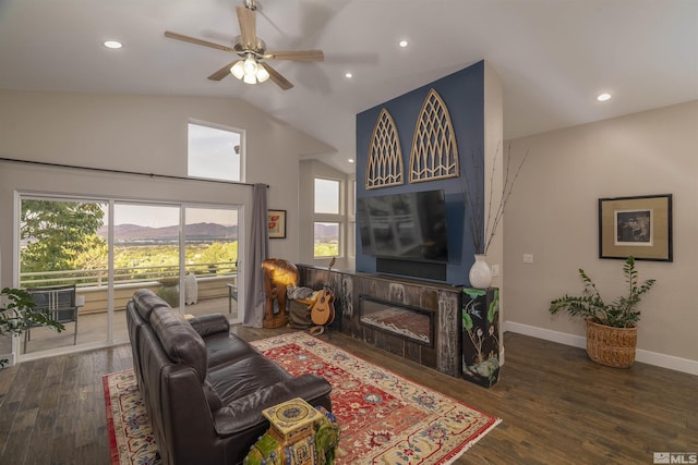 living room with a ceiling fan, wood finished floors, baseboards, lofted ceiling, and recessed lighting