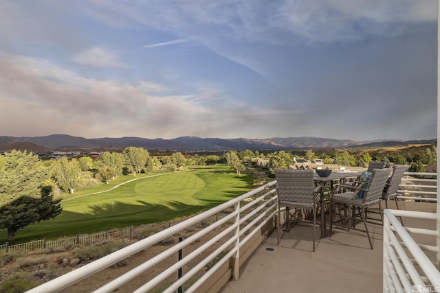 balcony with a mountain view and view of golf course