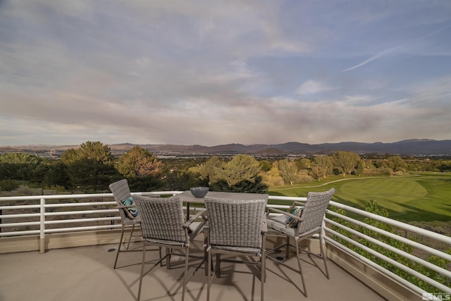 balcony with a mountain view and outdoor dining space