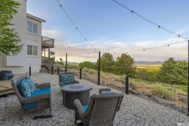 patio terrace at dusk featuring fence