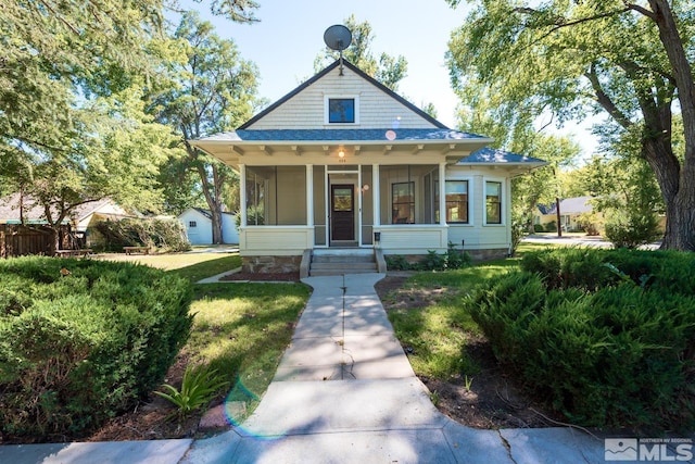 bungalow with a front lawn and covered porch