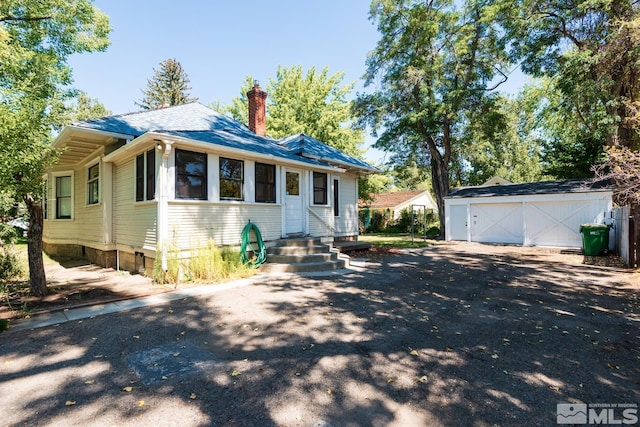 view of front of house featuring an outdoor structure and a garage