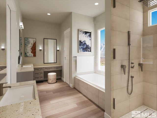 bathroom with vanity, a healthy amount of sunlight, and shower with separate bathtub