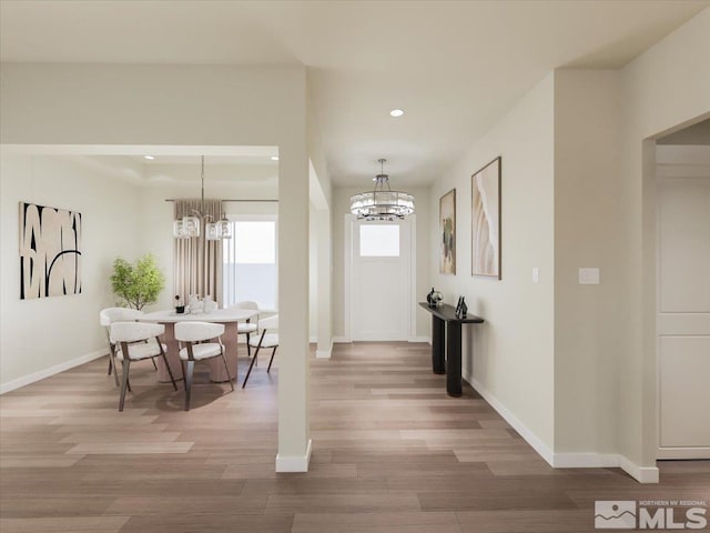 interior space with hardwood / wood-style flooring and an inviting chandelier