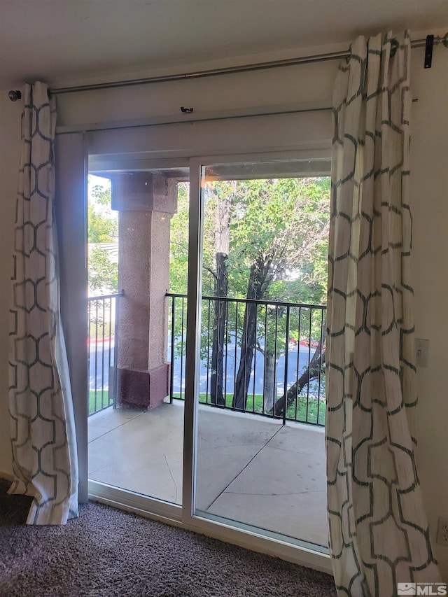 doorway featuring carpet flooring