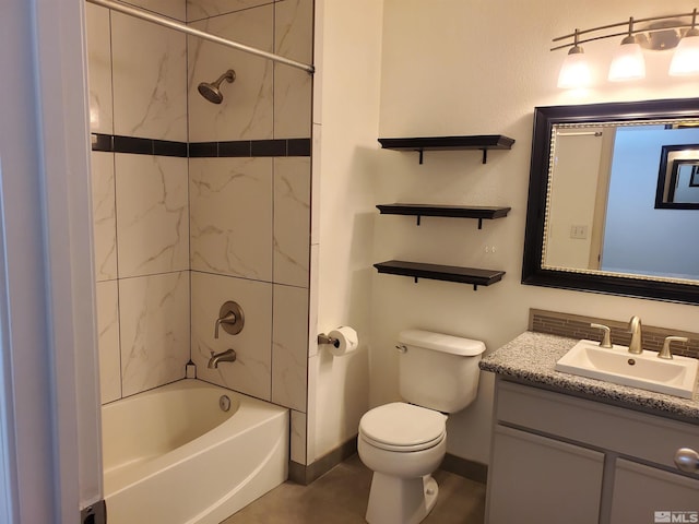 full bathroom with tile patterned floors, tiled shower / bath, toilet, and vanity