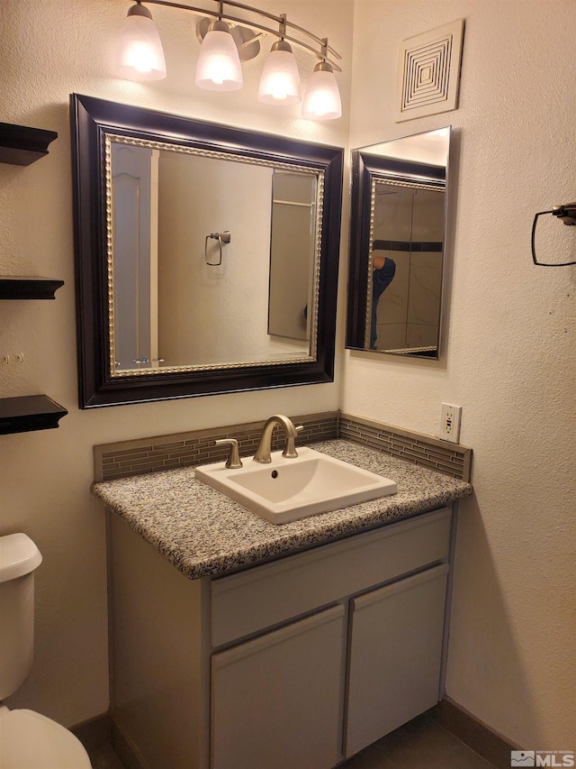 bathroom with toilet and vanity