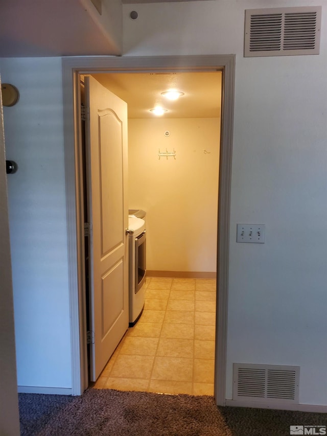 kitchen with light tile patterned flooring and washer / clothes dryer