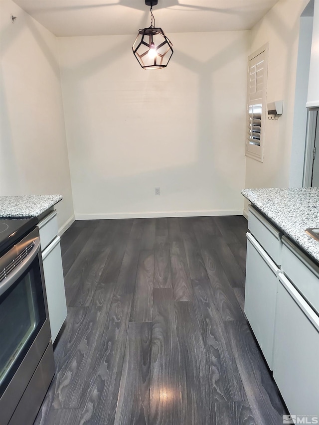 kitchen featuring decorative light fixtures, stainless steel range oven, and dark hardwood / wood-style floors