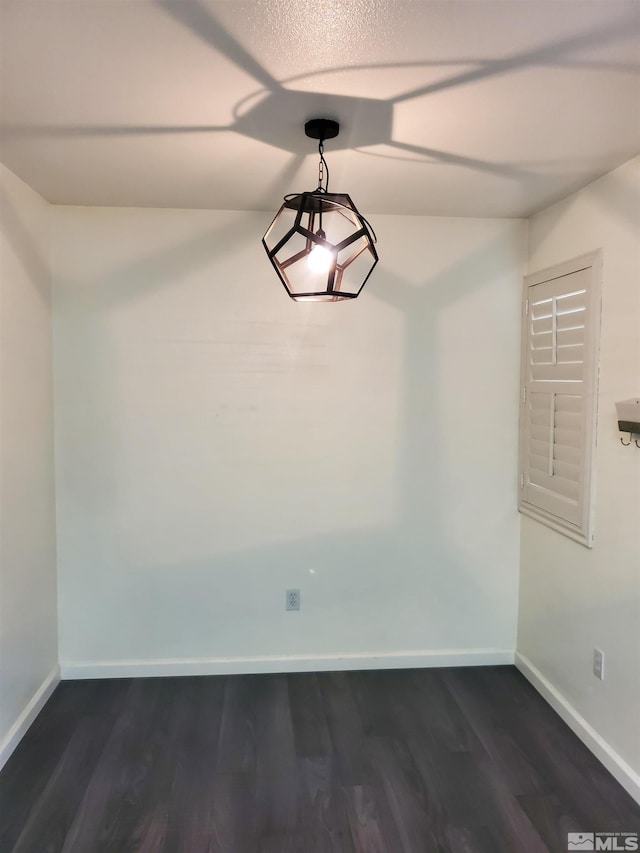 empty room featuring dark hardwood / wood-style flooring