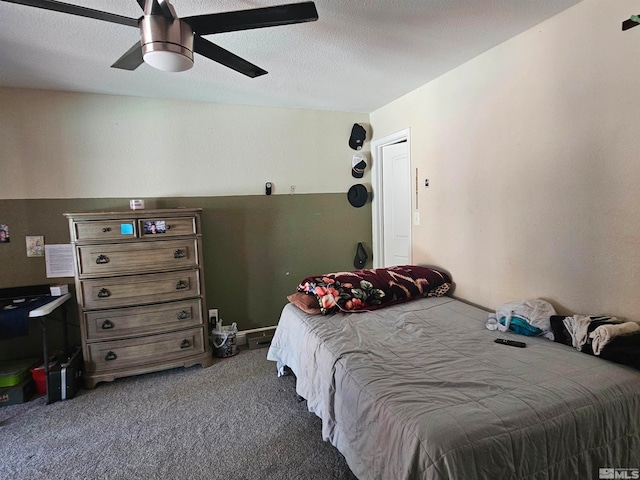 carpeted bedroom with a textured ceiling and ceiling fan