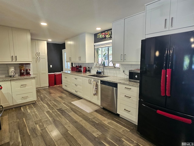 kitchen with stainless steel appliances, sink, decorative backsplash, dark hardwood / wood-style floors, and white cabinets