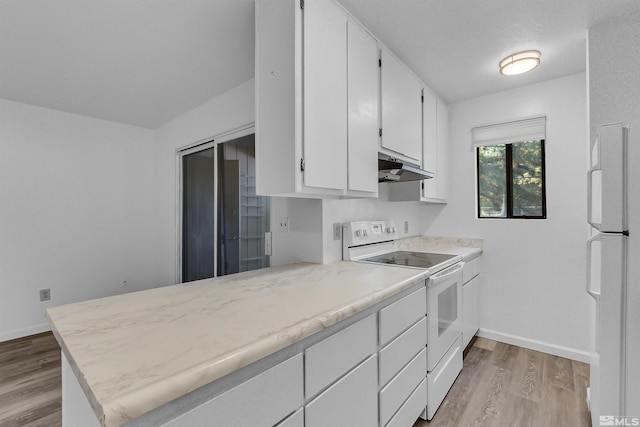 kitchen with light wood-type flooring, white appliances, kitchen peninsula, and white cabinets