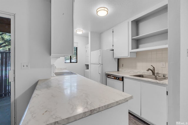 kitchen with white cabinets, white appliances, plenty of natural light, and sink