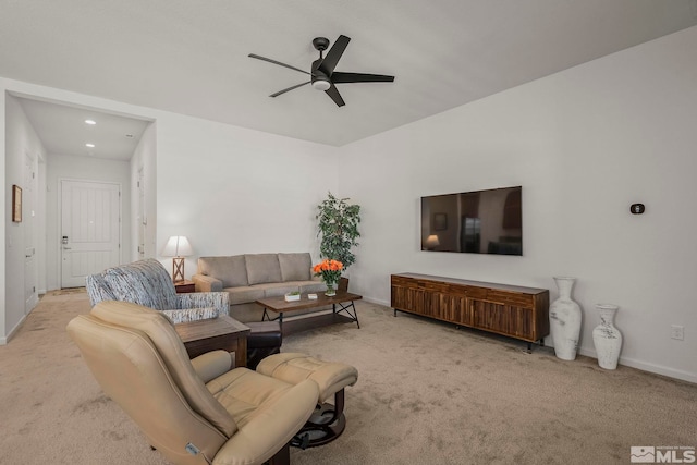 carpeted living room with a ceiling fan and baseboards