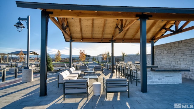 view of patio / terrace with outdoor dry bar, an outdoor hangout area, and a gazebo