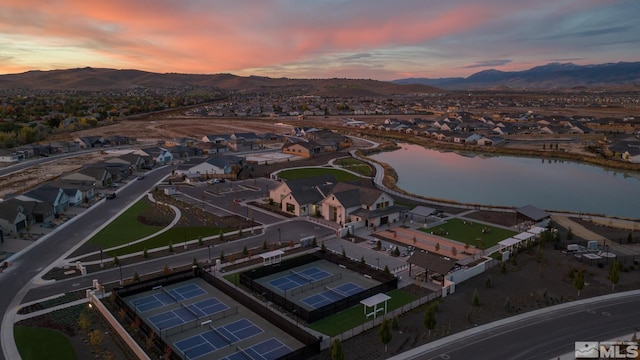 aerial view at dusk with a residential view and a water and mountain view