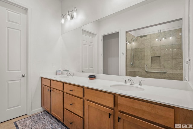 bathroom featuring a sink, a stall shower, and double vanity