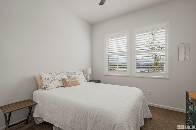 carpeted bedroom featuring a ceiling fan and baseboards