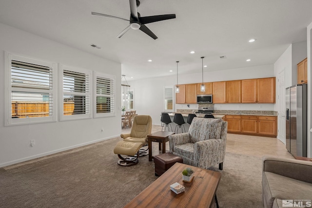 living area featuring visible vents, baseboards, ceiling fan, light colored carpet, and recessed lighting