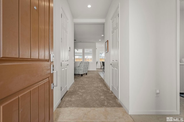 hall featuring recessed lighting, light colored carpet, and baseboards