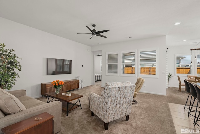 living area featuring visible vents, radiator heating unit, carpet, baseboards, and ceiling fan