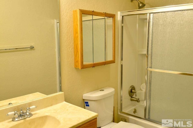 full bathroom with toilet, combined bath / shower with glass door, and vanity