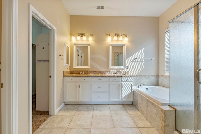 bathroom with vanity, plus walk in shower, and tile patterned flooring