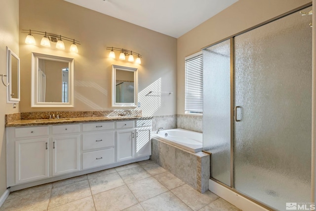 bathroom with tile patterned flooring, vanity, and plus walk in shower