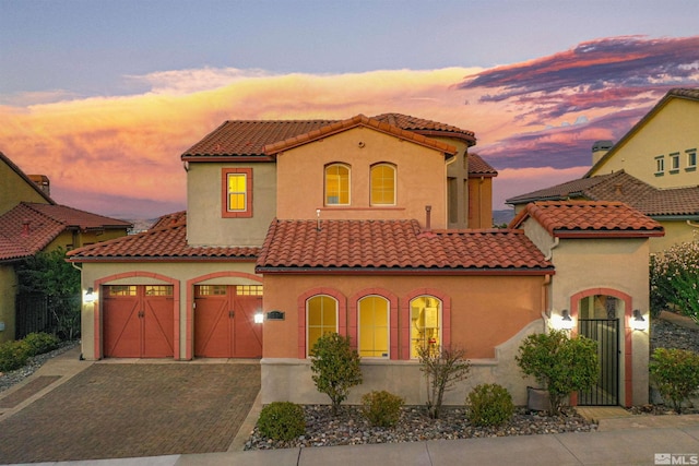 mediterranean / spanish-style home with a garage