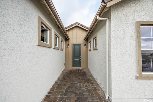 entrance to property featuring stucco siding