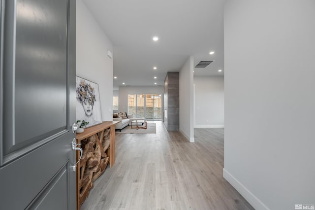 interior space featuring recessed lighting, light wood-style floors, visible vents, and baseboards