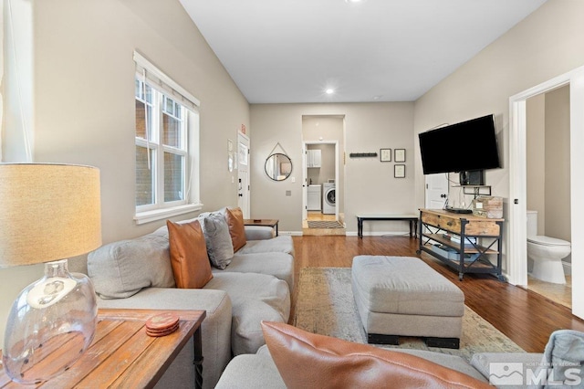 living room featuring hardwood / wood-style flooring and washer and dryer