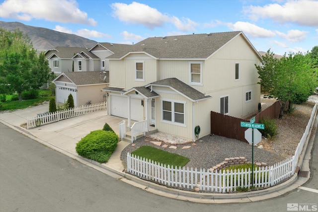 view of front of home with a mountain view and a garage