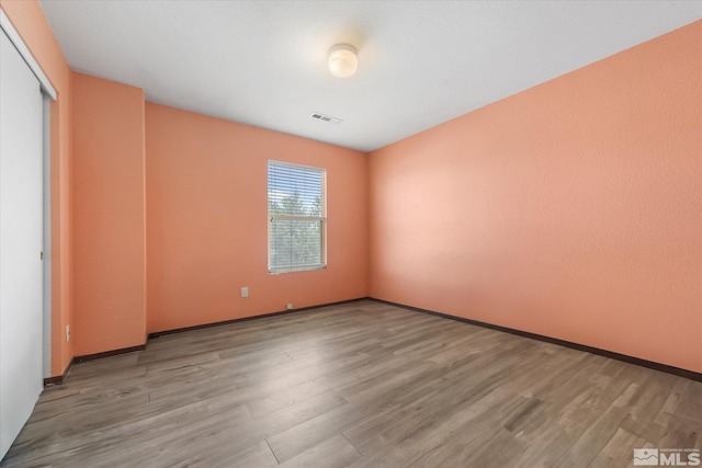 spare room featuring light wood-type flooring