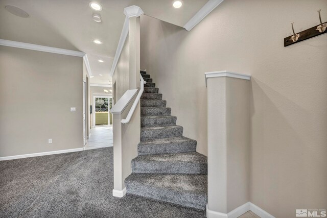 stairway featuring carpet floors and ornamental molding