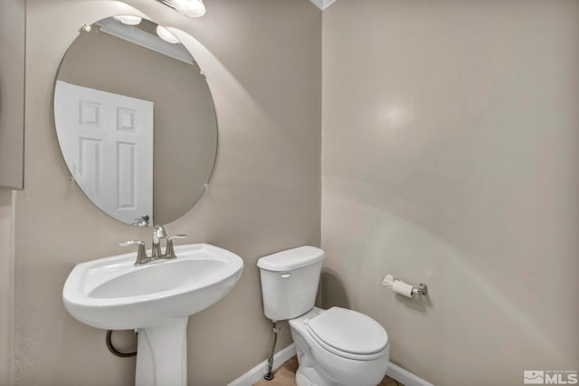 bathroom featuring toilet and ornamental molding