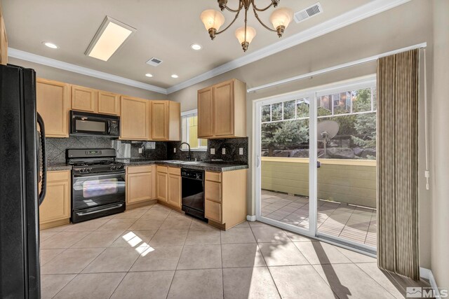 kitchen featuring black appliances, a chandelier, crown molding, and sink