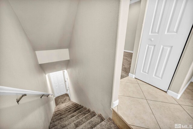 stairs featuring tile patterned flooring