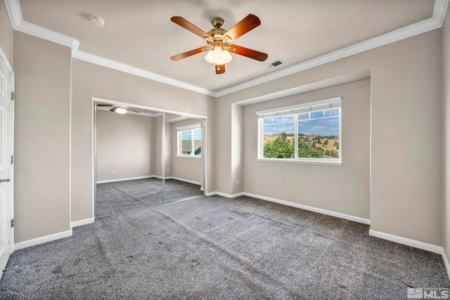 spare room featuring ornamental molding, ceiling fan, and carpet