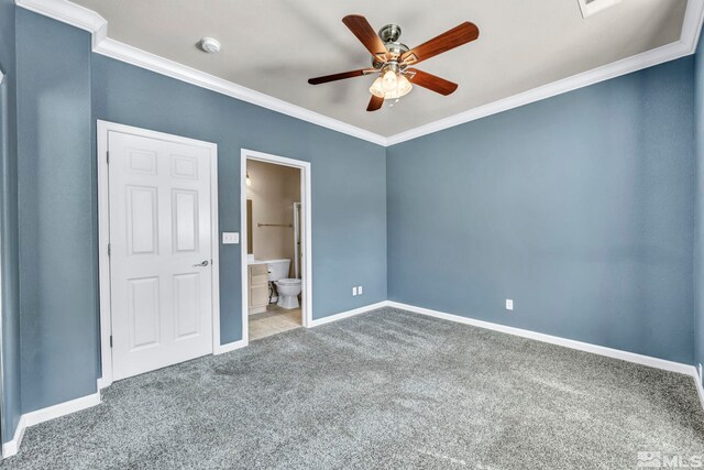 unfurnished bedroom with carpet flooring, ornamental molding, ensuite bath, and ceiling fan