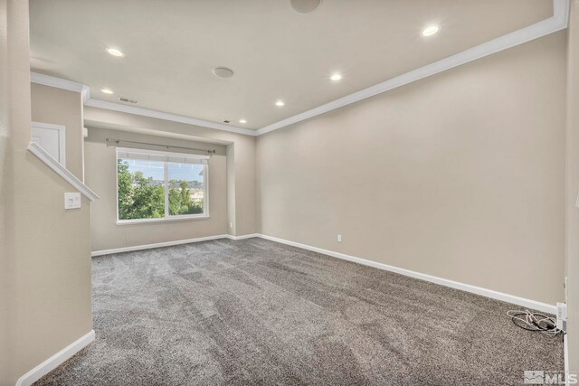 spare room with crown molding and carpet flooring