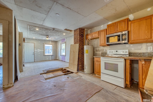 kitchen featuring ceiling fan, white range with electric cooktop, and water heater