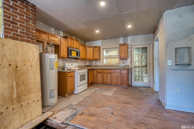 kitchen with water heater, white electric range oven, and light hardwood / wood-style floors