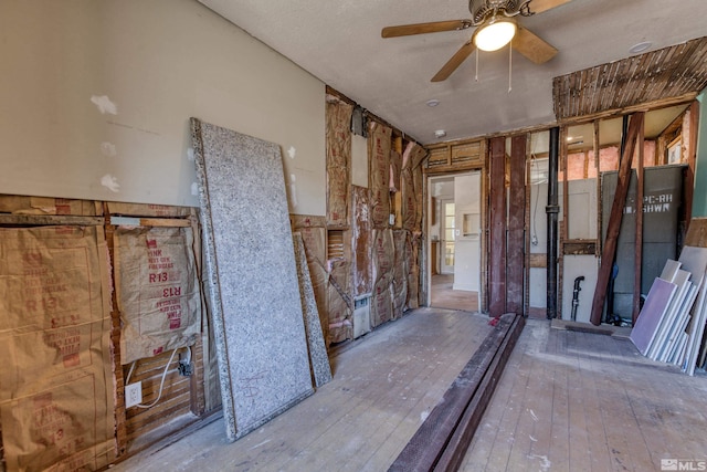 misc room with light wood-type flooring, a textured ceiling, and ceiling fan