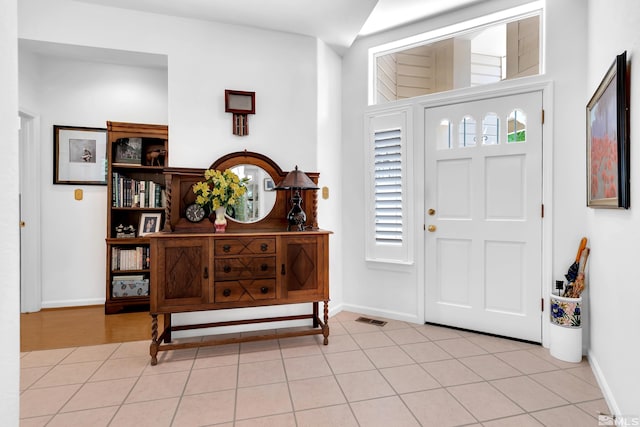 entryway featuring a wealth of natural light and light tile patterned flooring