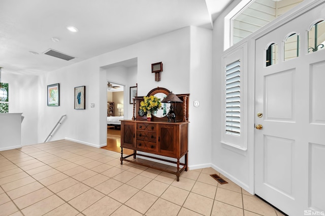 tiled foyer with ceiling fan