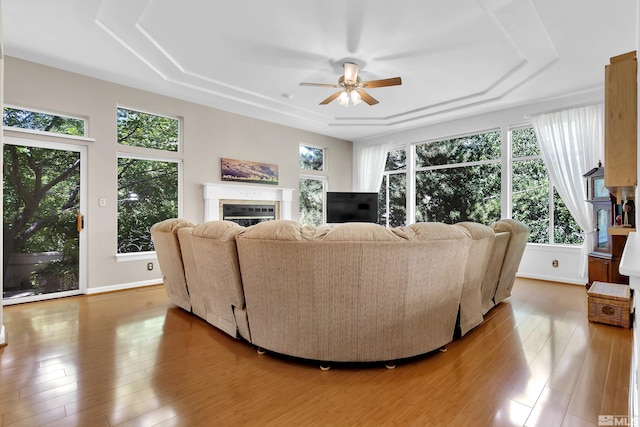 living room with light hardwood / wood-style flooring and ceiling fan